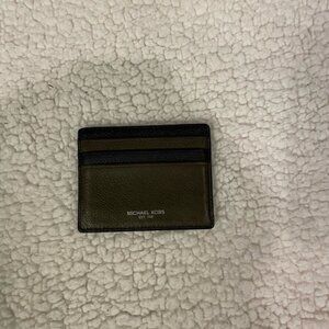 Michael Kors green and black card holder. Holds 7 cards.